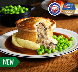 Brewers Fayre Chicken and Mushroom pie on a plate with mashed potatoes, green peas and gravy.
