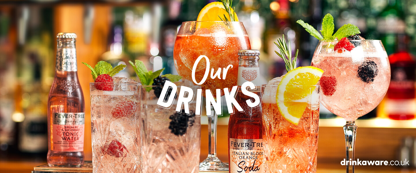 A selection of Brewers Fayre drinks including fruit garnishes and bottles of soda and tonic water.