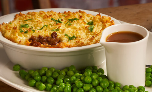 Cottage pie served with peas and gravy