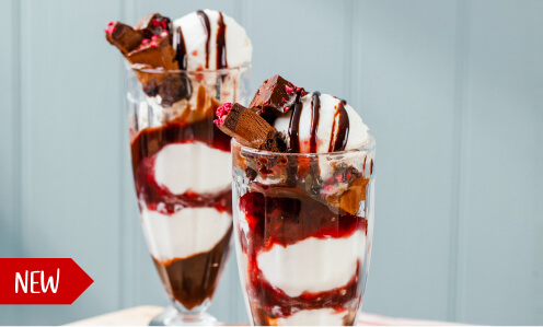 Two black forest sundaes served on a table